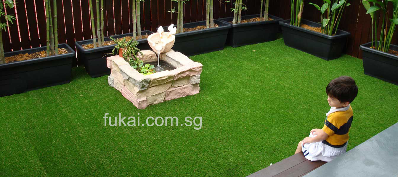 kid in the middle of beautiful artificial green grass landscape